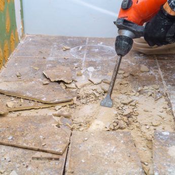 worker-remove-demolish-old-tiles-in-a-bathroom-wi-2021-08-29-01-24-04-utc